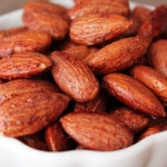 A small bowl filled with maple almonds.