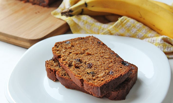 Two slices of banana bread on a white plate.