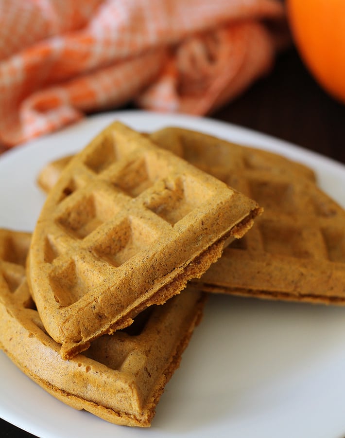 Vegan Gluten Free Pumpkin Spice Waffles on a white plate.