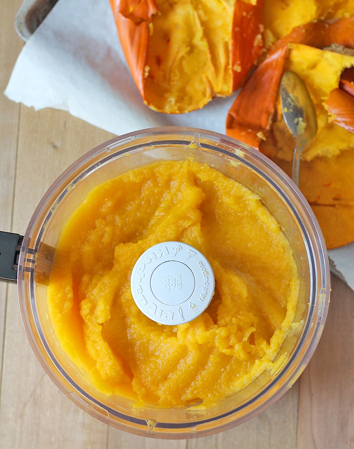 How to Make Homemade Pumpkin Puree - Overhead shot of processed pumpkin puree in a food processor.