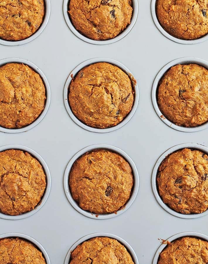 Carrot Coconut Muffins in a muffin pan just out of the oven.