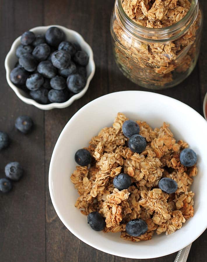 Overhead shot of a bowl of nut free granola and blueberries.