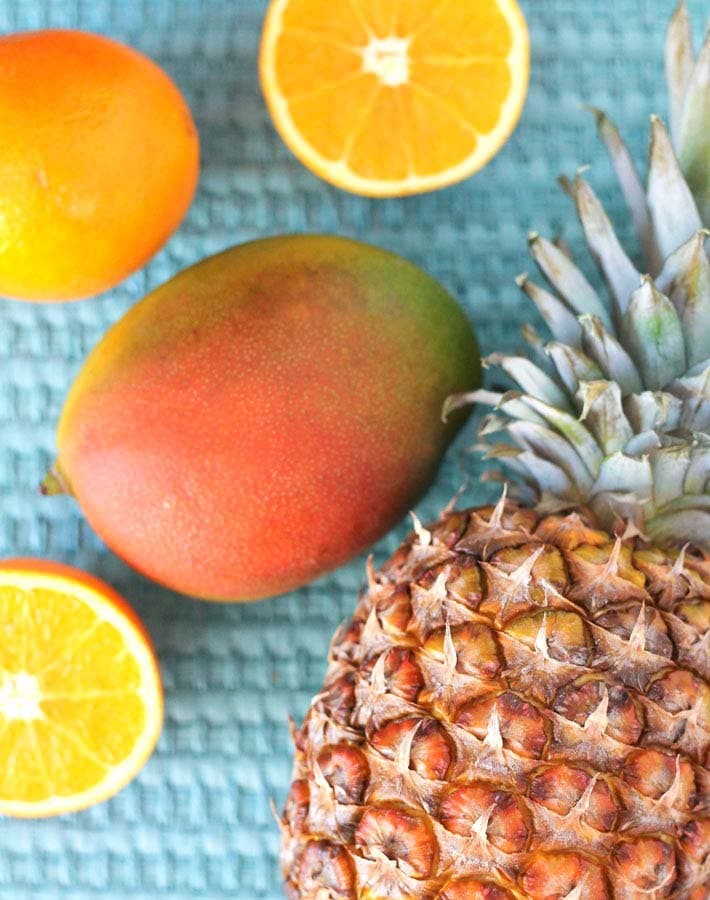 Fresh fruit ingredients needed to make Pineapple Orange Mango Juice.