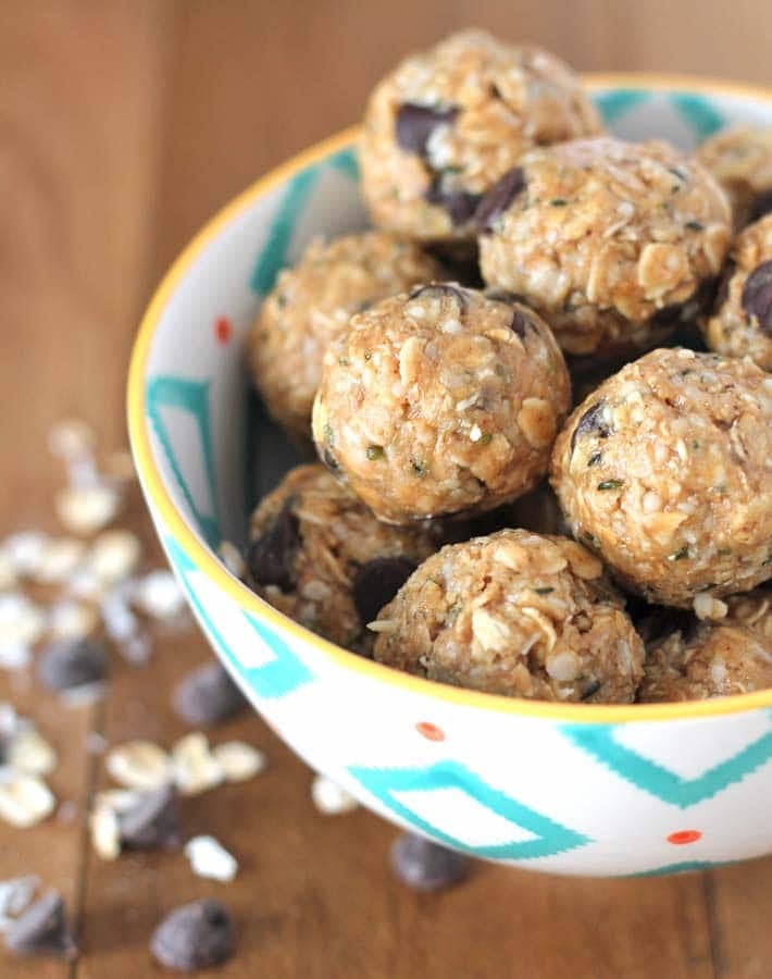 No Bake Peanut Butter Coconut Balls in a patterned bowl on a wood table.