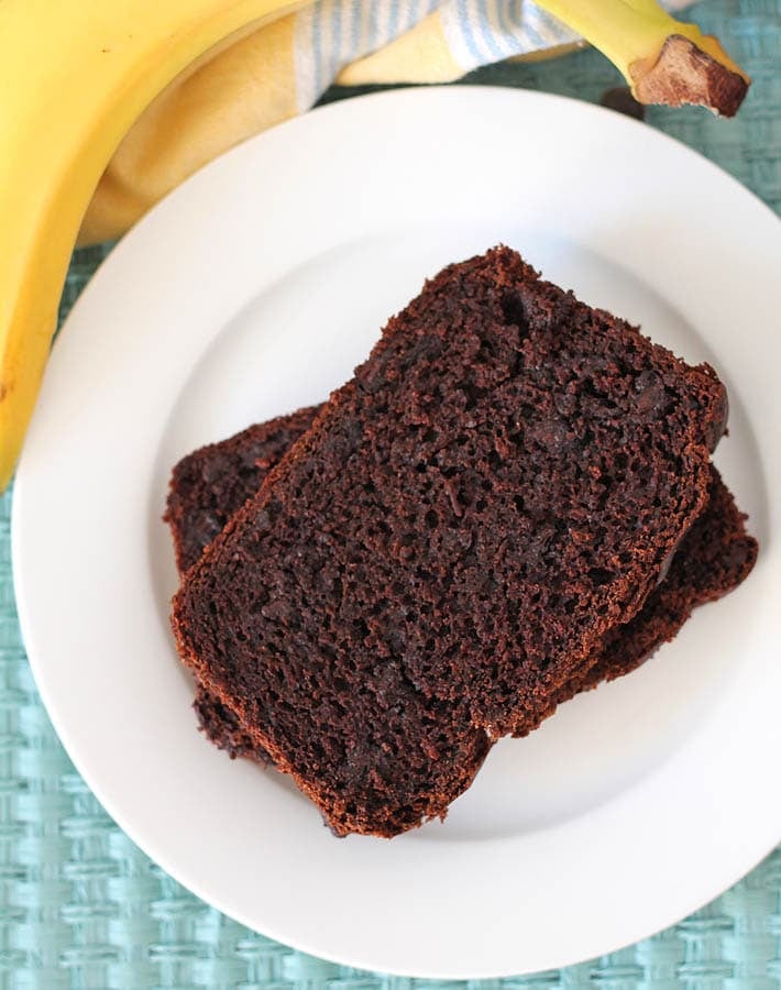 Close up shot of Vegan Chocolate Banana Bread on a small white plate.