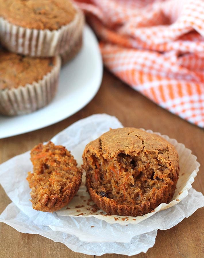 Carrot Ginger Muffins on a brown wooden table.