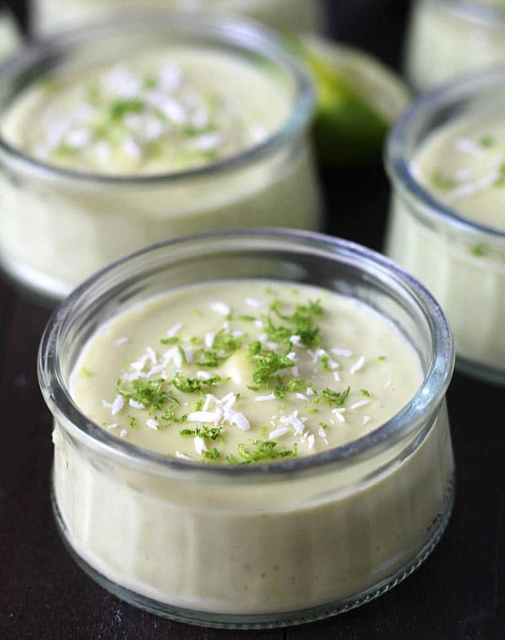 Key Lime Cups in glass jars on a table.