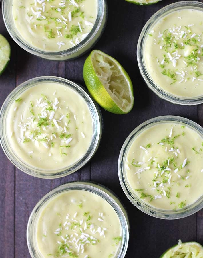 Overhead shot of vegan Key Lime Cups sitting on a dark wood table.