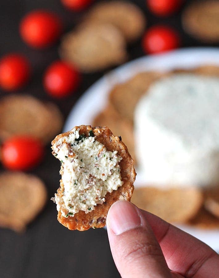 Close up shot of garlic herb vegan almond cheese spread.