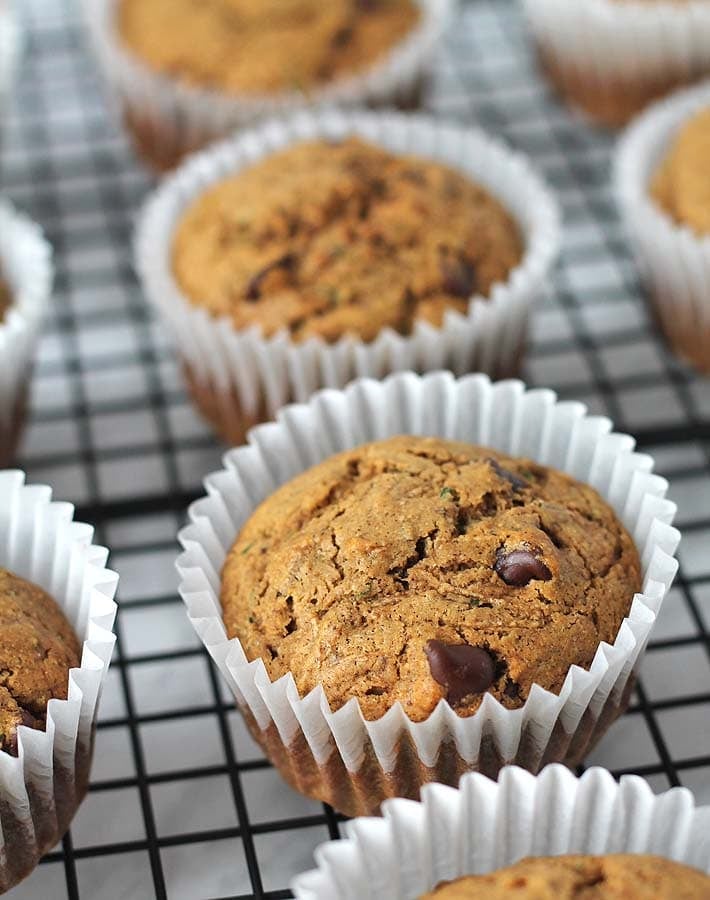 Vegan Gluten Free Zucchini Chocolate Chip Muffins sitting on a cooling rack.