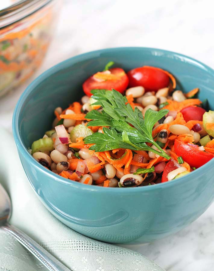 An up close shot of Simple Black-Eyed Pea Salad in a blue bowl.