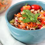 Simple Black-Eyed Pea Salad in a blue bowl with a spoon on the side.