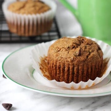 Vegan Gluten Free Zucchini Chocolate Chip Muffins sitting on a small plate.