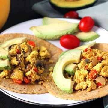 Close up shot of two Southwest Tofu Scramble Breakfast Tacos on a plate.