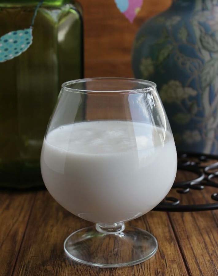 Vegan cashew coffee creamer in a glass on a wooden table