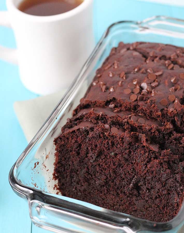 Sliced Vegan Gluten Free Chocolate Zucchini Bread sitting in a baking dish