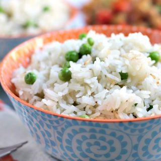 Easy Instant Pot Vegan Recipes - Instant Pot Coconut Jasmine Rice with green peas in a blue and white bowl.