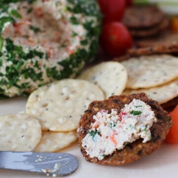 A cracker with vegan cheese spread.
