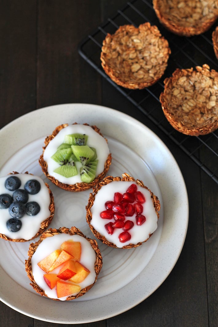 Grab the recipe for these easy-to-make fruit and yogurt granola cups that are great to have a breakfast, to serve at brunch or for snacking on. Plus, they can be filled with anything you like, not just fruit and yogurt! #granola #brunch #veganbreakfast #veganbrunch #granolacups