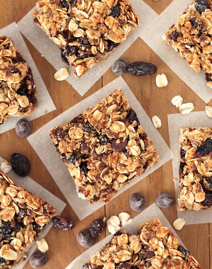 Overhead shot of vegan granola bars sitting on a brown wood table.