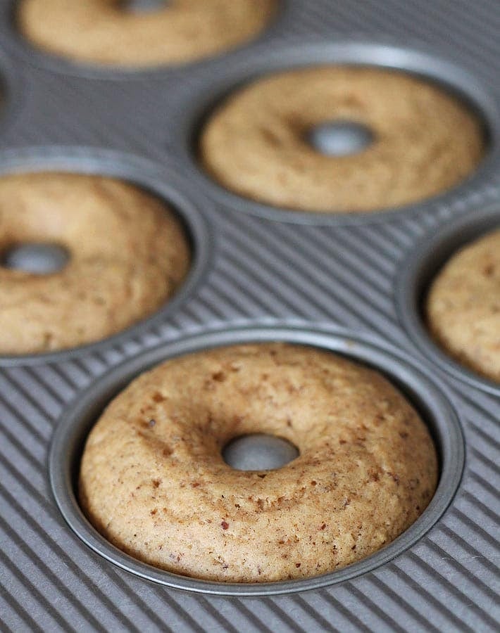 Fresh out of the oven Vegan Gluten Free Maple Doughnuts in a doughnut pan.