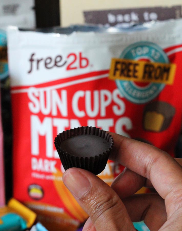 A Free2B mini sun cup being held up in front of its package.