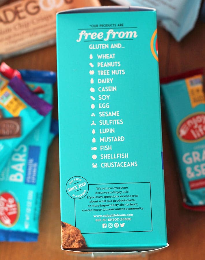A box of cookies on its side to show the label that lists all the allergen ingredients not included in the product.