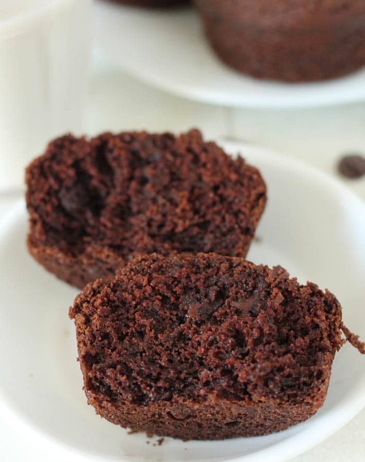 A Vegan Gluten Free Chocolate Zucchini Muffin split open to show the inner texture.