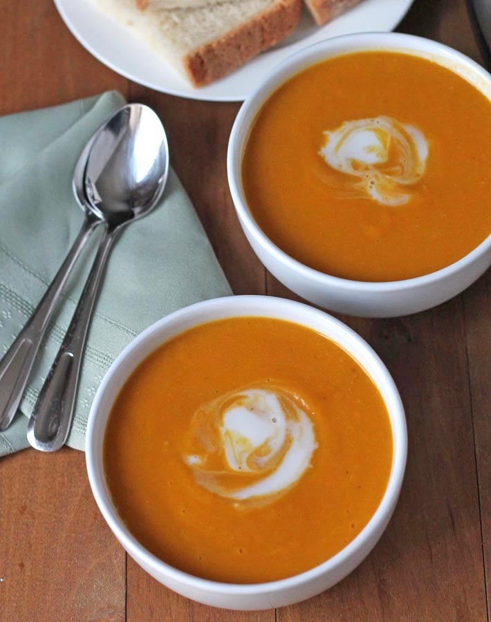 Overhead shot of two bowls of Cauliflower Sweet Potato Soup.