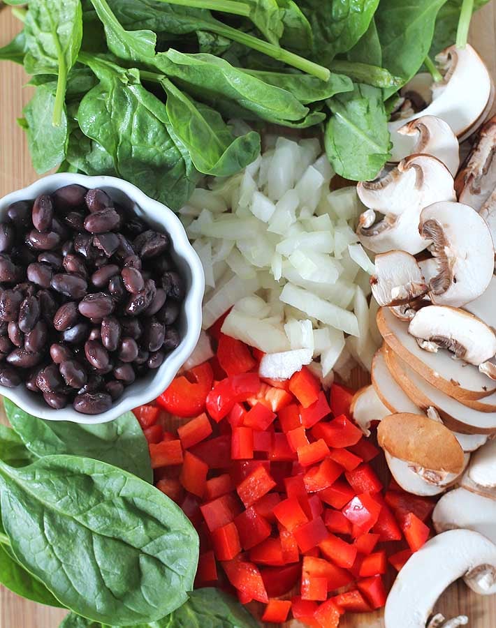 The ingredients for Tofu Breakfast Burritos on a cutting board.