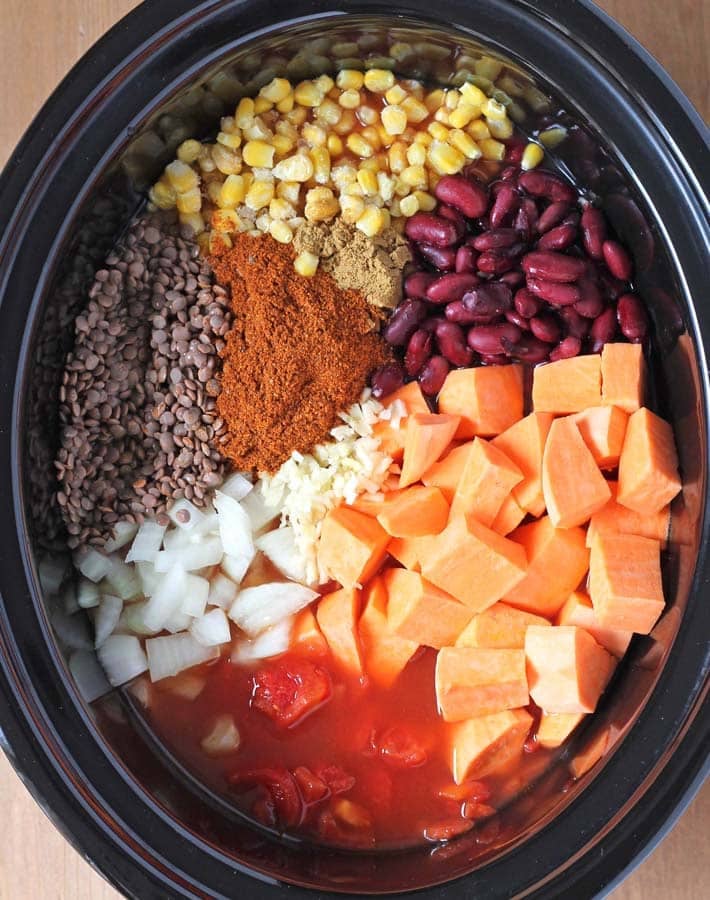 The ingredients for Lentil Sweet Potato Chili in a slow cooker before it gets cooked.