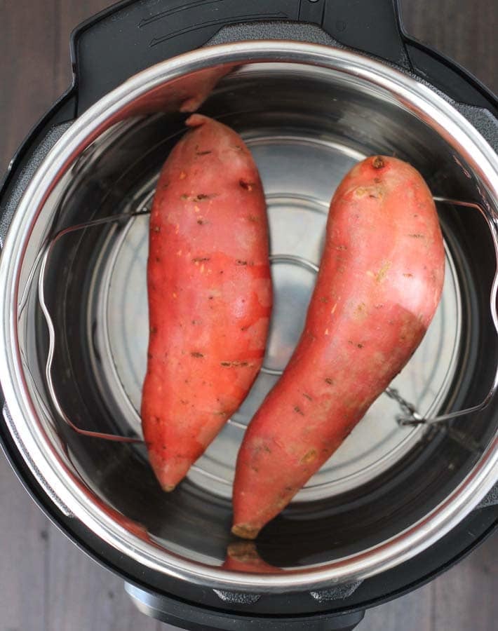 Two raw sweet potatoes in an Instant Pot to make Instant Pot Sweet Potatoes.