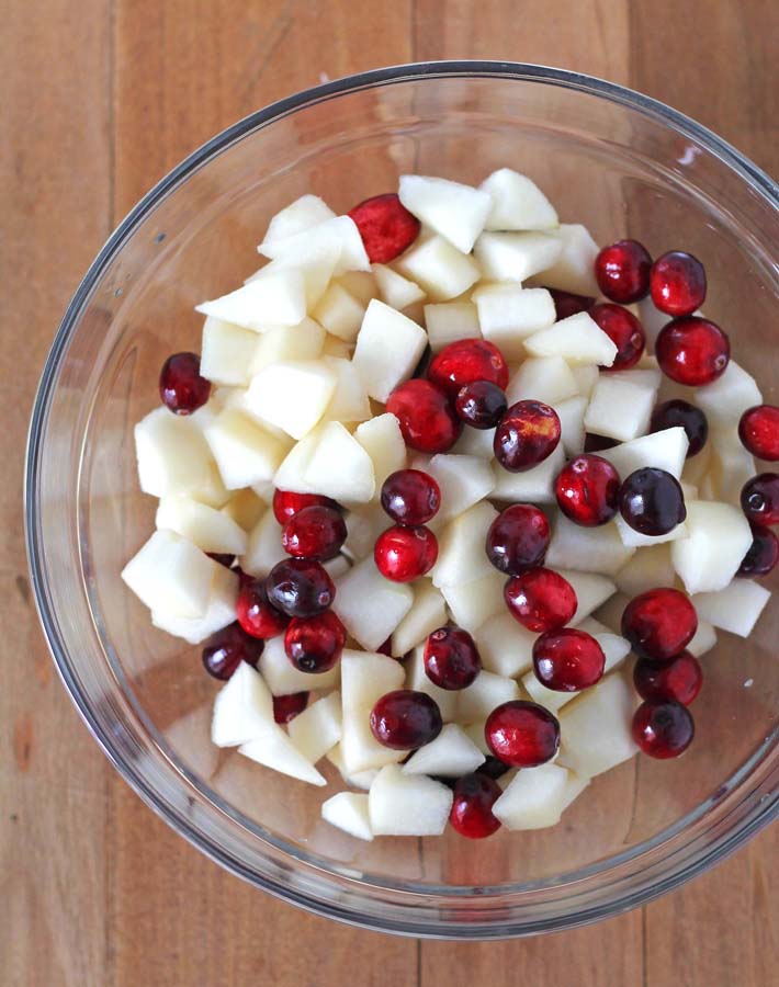 Fresh cranberries and pears in a glass bowl to make Pear Cranberry Crisp.
