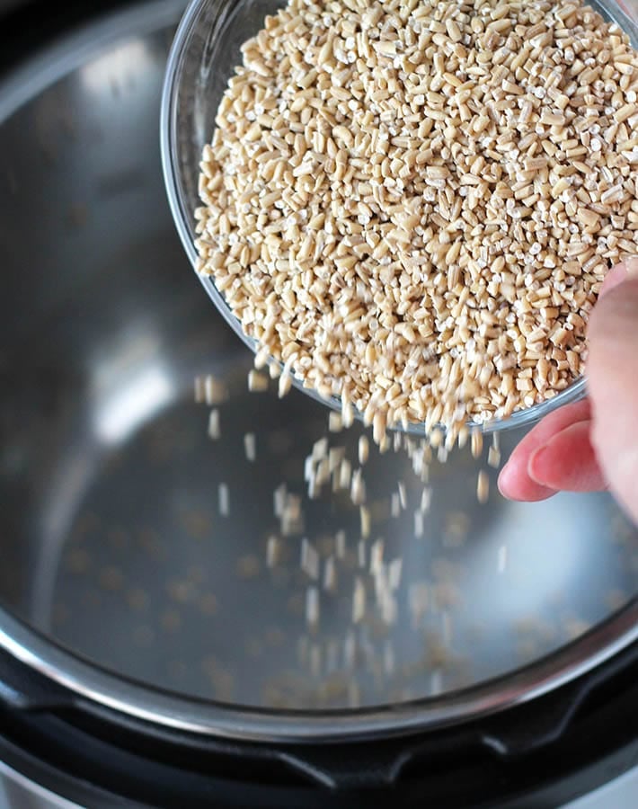 Steel cut oats for Banana Steel Cut Oats being poured into an Instant Pot.