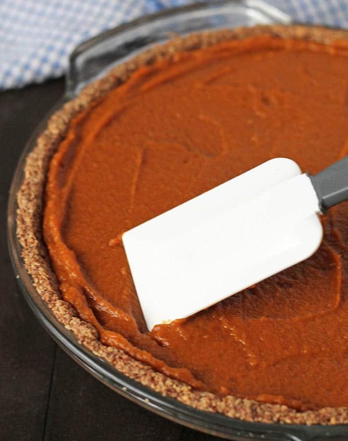 The filling for Vegan Sweet Potato Pie being smoothed out in a pie plate.