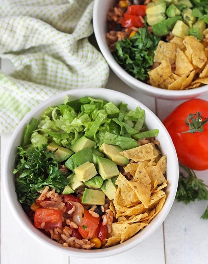 Overhead picture of two Taco Rice Bowls on a white table.