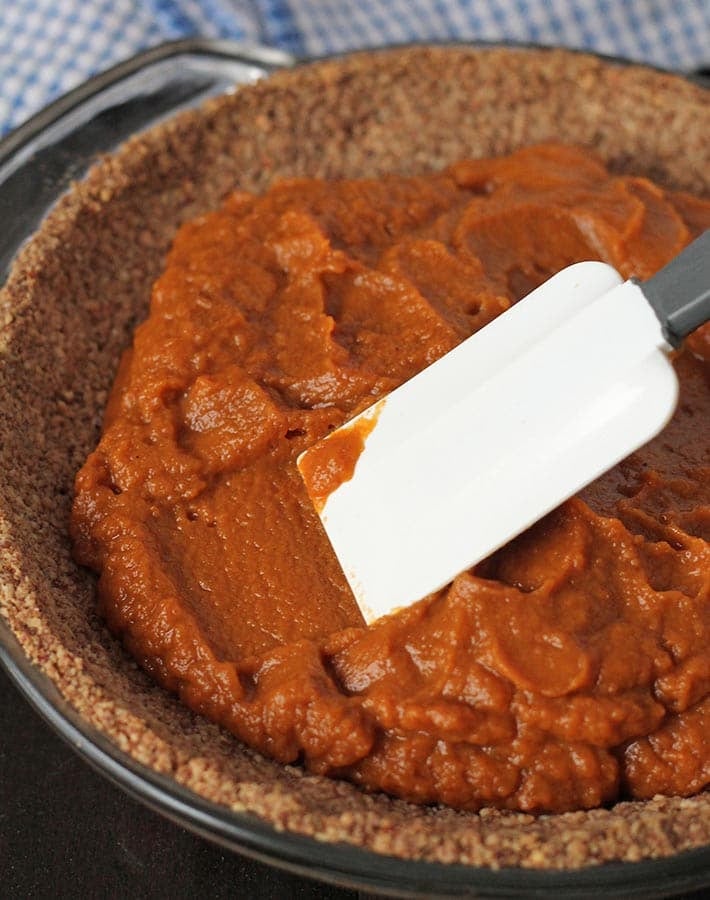 The filling for Vegan Sweet Potato Pie being spread in the pie crust.