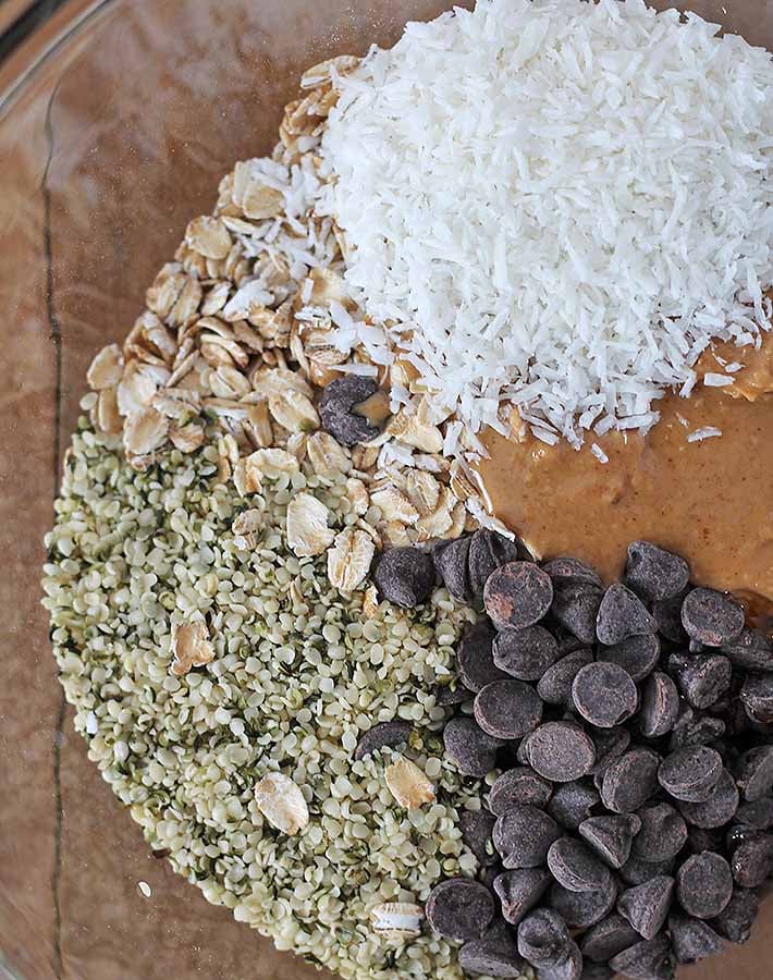 An overhead shot of the ingredients for No Bake Peanut Butter Coconut Balls in a glass bowl.