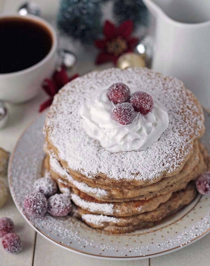 A stack of vegan eggnog pancakes on a plate.