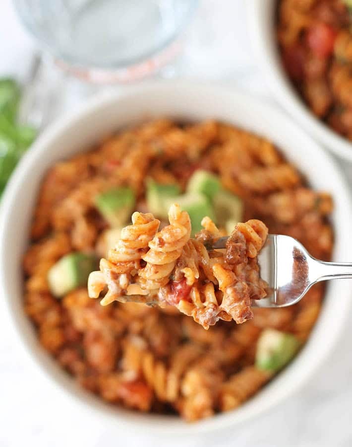 A closeup shot of a forkful of One Pot Cheesy Taco Pasta.