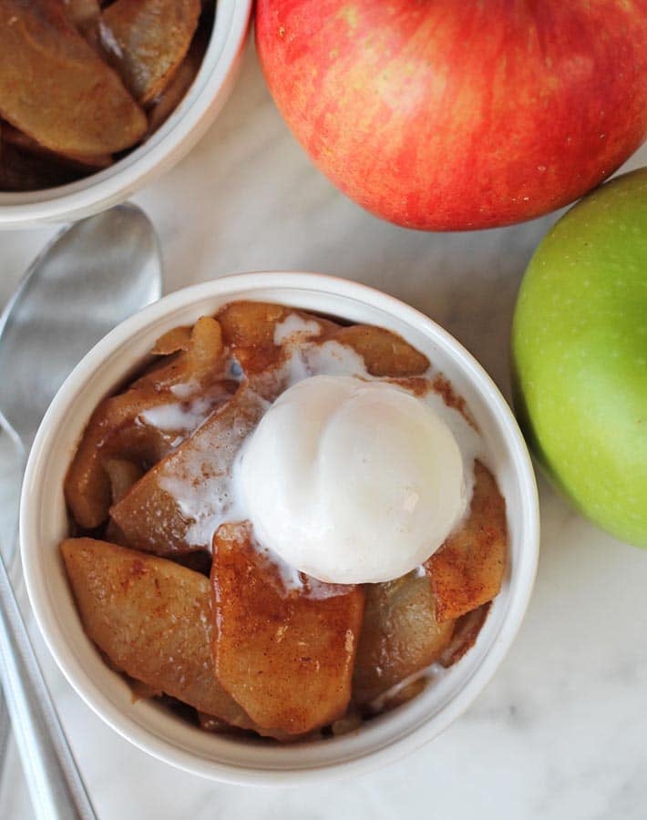 Overhead shot of a bowl with baked cinnamon apple slices.