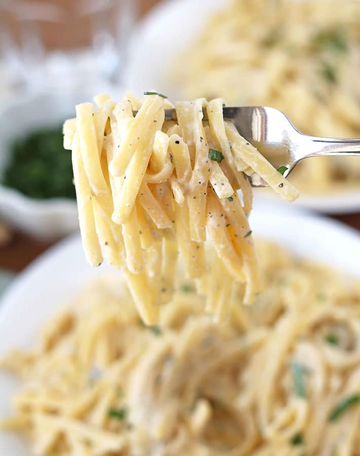 A fork holding up a fork full of Vegan Garlic Pasta Sauce.
