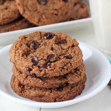 Vegan Almond Butter Cookies on a small round plate, more cookies sit on a plate in the background.