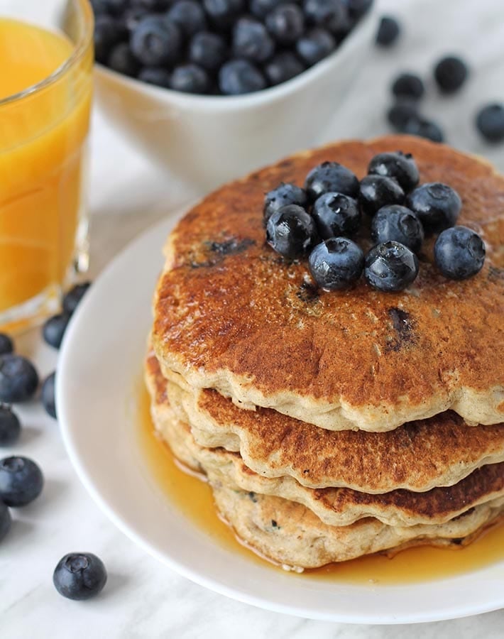 A stack of egg free blueberry pancakes on a plate.