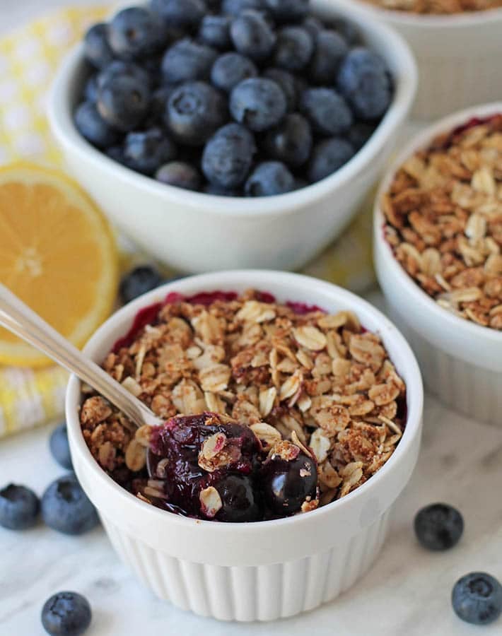 Gluten Free blueberry crisp in a white ramekin.