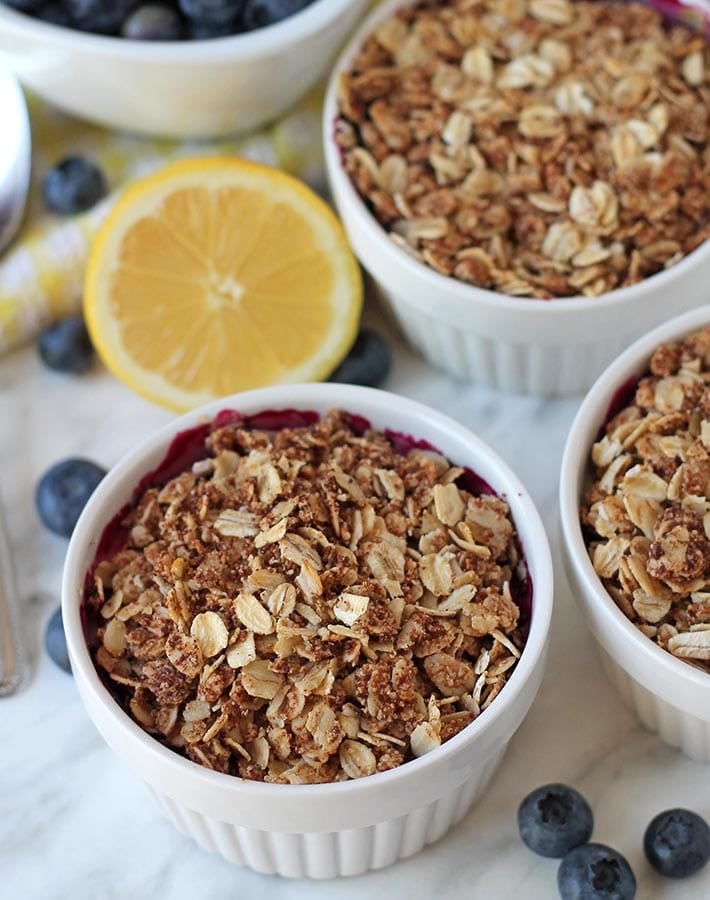 Vegan blueberry crisp in white ramekins.