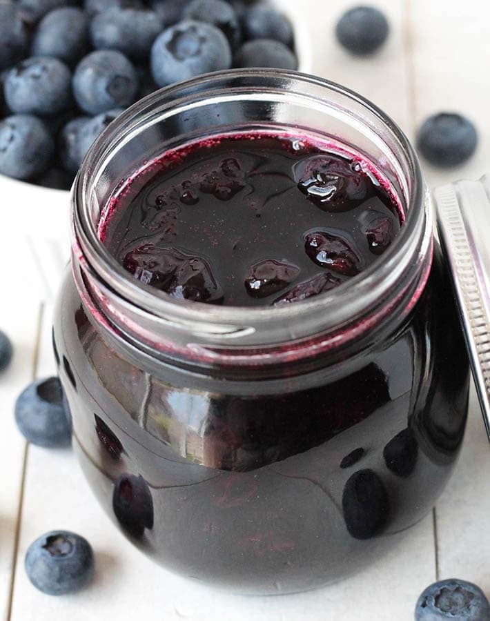 A small glass jar filled with easy blueberry compote.