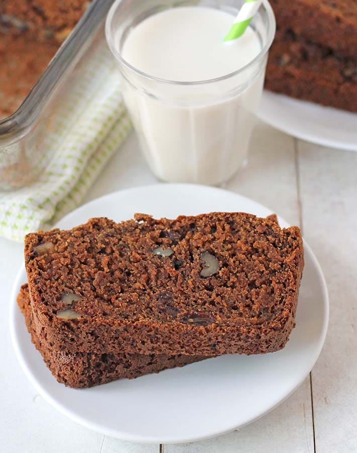 Two slices of gluten free egg free zucchini bread on a white plate.