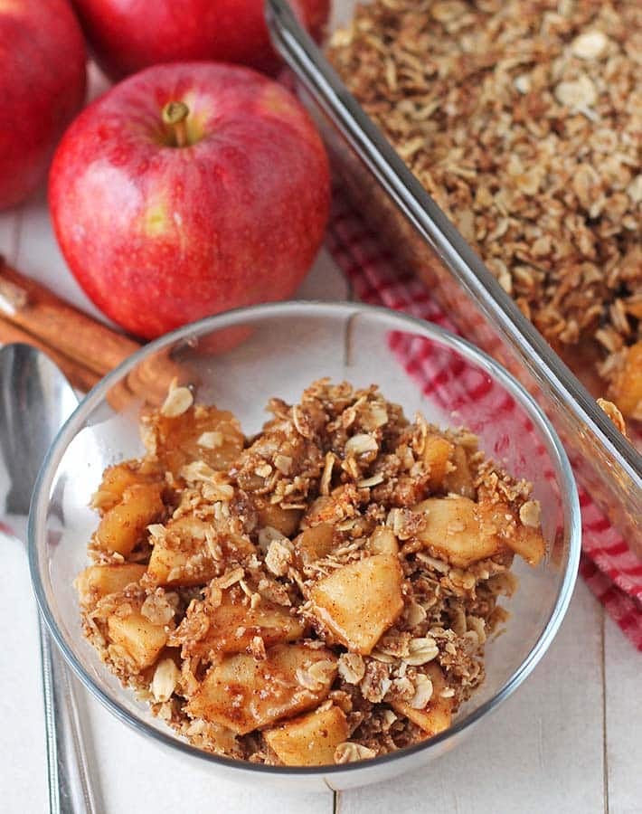 Overhead shot of gluten free apple crisp in a small glass bowl.