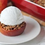 Close up shot of a gluten free baked apple with a scoop of ice cream on top.
